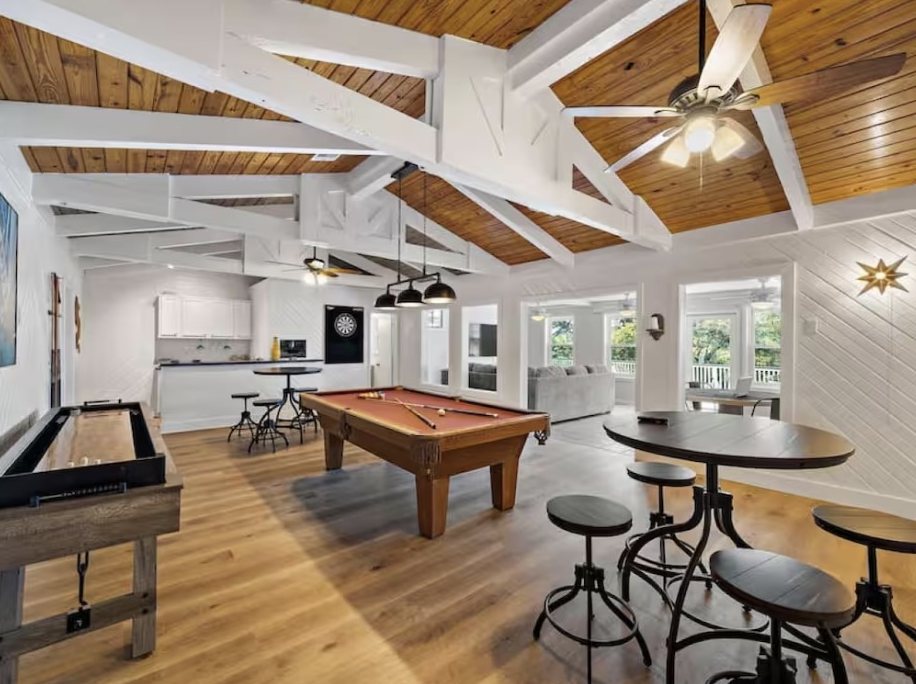 Game room with pool table and high-top tables