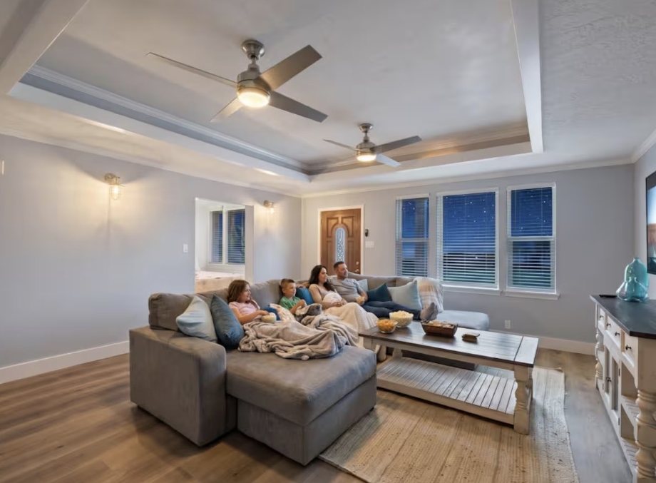 Main living room with sectional and tray ceiling