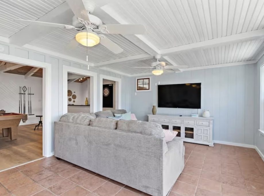 Sunroom lounge with TV and card tables