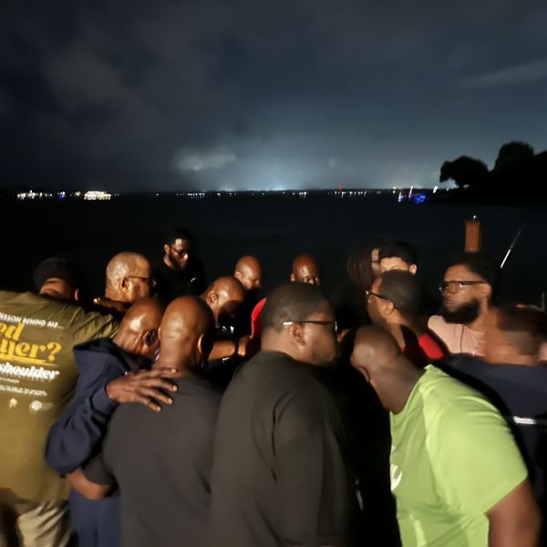 Night prayer huddle by the lake